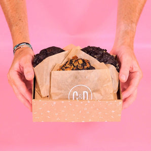 Hands holding a box of 3 x New York Cookies, The Dark Chocolate Lovers Box by Crumbs & Doilies